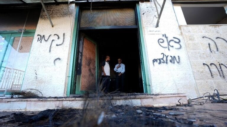 Murs calcinés et graffitis suite à l'attaque de deux mosquées incendiées par des colons en Cisjordanie occupée.